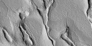 Close view of terrain caused by ice leaving the ground, as seen by HiRISE under HiWish program
