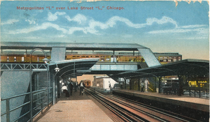 A view of a train station looking straight on, with a perpendicular train station located immediately above the trackage