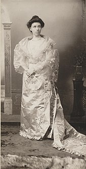 Helen Taft stands while wearing an ornate gown