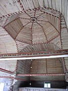 There are influences from the vaults of stone churches in the forms and decorative paintings of the ceiling