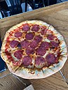 Pizza with salami and mozzarella stuffed crust at restaurant in Ivano-Frankivsk, October 2021