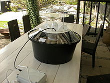 A large circular machine sitting on an outdoor table