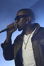 Kanye West performing, wearing sunglasses