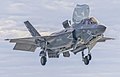 An F-35 hovering over the USS America