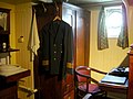 Officer quarters on board the ship. Uniform of Master mariner is visible.