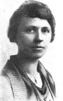 A young white woman with dark hair, wearing loose-fitting clothing