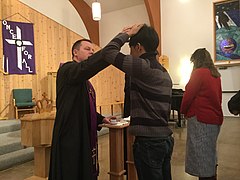 A Lutheran pastor distributes ashes to a communicant during a Divine Service, 2017