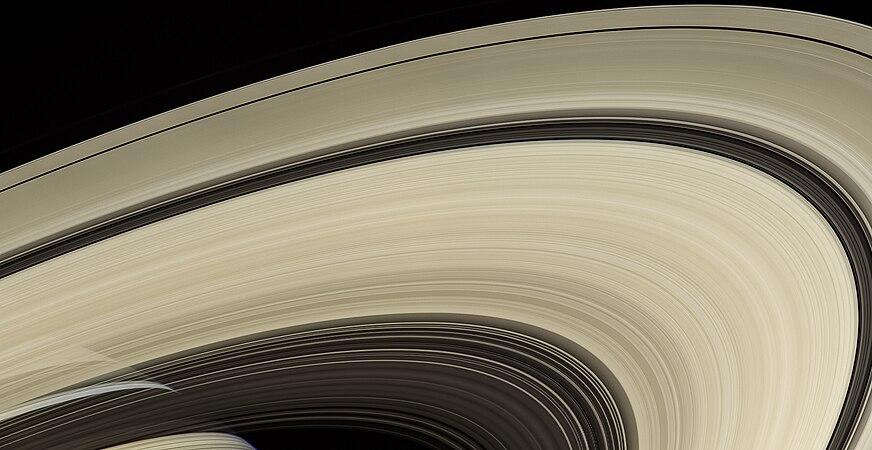 Saturn, behind the rings and draped with their shadows, as seen by Cassini from a distance of 725,000 km (450,000 miles).