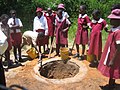 School children in Zimbabwe digging a shallow pit for an Arborloo toilet (a variation of a pit latrine), Epworth in Harare, Zimbabwe