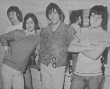 A black-and-white photo of the Kinks in a hotel room