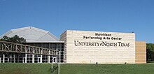 Large building with the words "Murchison Performing Arts Center University of North Texas" displayed in large letters.
