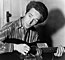 Woody Guthrie playing a guitar