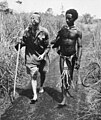 Image 14An Australian soldier, Private George "Dick" Whittington, is aided by Papuan orderly Raphael Oimbari, near Buna on 25 December 1942. (from History of Papua New Guinea)