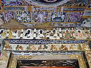 Cave 17 verandah doorway; eight Buddhas above eight couples[99][100]