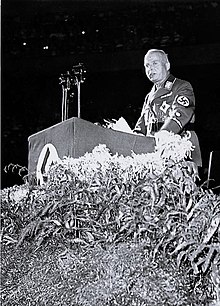 Charles Edward in a Nazi party uniform, speaking at a podium