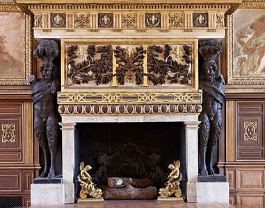 Renaissance fireplace with atlantes in the ballroom of the Palace of Fontainebleau, France