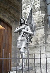 Joan of Arc statue in front of Basilique Sainte-Jeanne-d'Arc in Paris.
