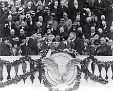 Hoover faces Chief Justice Taft. A large crowd stands behind them.