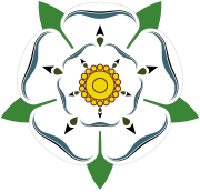 This is the White Rose of York, a white heraldic rose, which is the symbol of the House of York. Traditionally the origins of the emblem are said to go back to Edmund of Langley in the 14th century, the first Duke of York and the founder of the House of York as a Cadet branch of the then-ruling House of Plantagenet.[20] The actual symbolism behind the rose has religious connotations as it represents the Virgin Mary, who was often called the Mystical Rose of Heaven.[20][21]