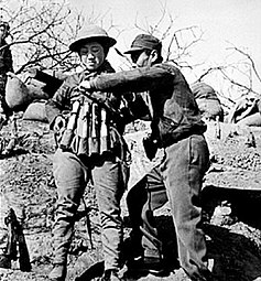 Chinese suicide bomber putting on an explosive vest of M24 style hand grenades to use against Japanese tanks at the Battle of Taierzhuang