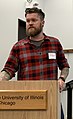 Image 116American man wearing a slim-fitting flannel shirt, a beard, and an undercut, 2019. Sleeve tattoos can be seen. (from 2010s in fashion)