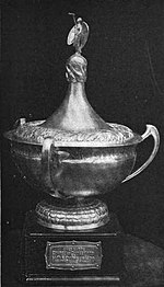 Black and white photograph of a loving cup mounted on a pedestal