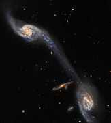 This image from the NASA/ESA Hubble Space Telescope shows two of the galaxies in the galactic triplet Arp 248. [21]