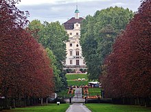 The Alter Hauptbau, seen through the trees from the path to Schloss Favorite