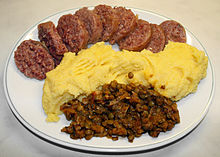 Cotechino Modena (at top) served with polenta and lentils