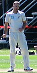 An cricketer from New Zealand wearing white Test cricket outfit.
