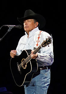 A photo of George Strait holding a guitar
