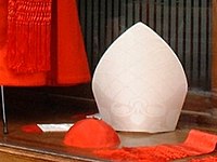 Mitre simplex traditional style: White damask with its white lappets ending in red fringes.