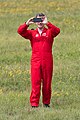 Pilots of the Red Arrows wear red flying suits.