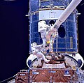 Astronauts work on installing Hubble's corrective optics during Servicing Mission 1.