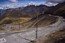 Winding mountain road, with messages painted on the pavement