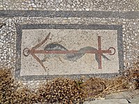 A mosaic with a dolphin and anchor design