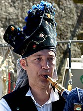 A bagpiper with monteira (hat)
