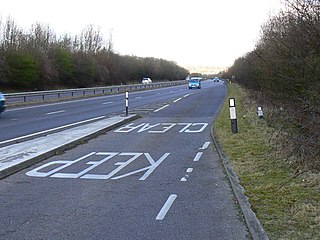 Road surface marking warning text is predistorted for oblique viewing by motorists