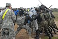 Soldiers from Kansas and Armenia practice a riot control exercise