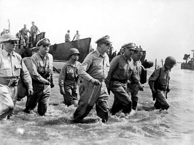 Douglas MacArthur wades ashore during the initial landings at Leyte