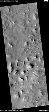 Wide view of layered buttes and small mesas, as seen by HiRISE under HiWish program. Some dark slope streaks are visible.