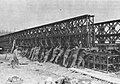 U.S. combat engineers slide stacked doubled sections of Bailey bridging into place at Wesel on the Rhine in Germany (c. 1945)
