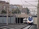 A high-speed train entering the station from the east.