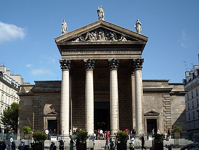 The façade, topped with statues of Faith, Charity and Hope