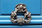 A door knocker with putti holding a cartouche, in Paris