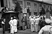U.S. servicemen entering Recreation and Amusement Association during Occupation of Japan.