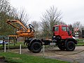 Unimog with a flail hedge and verge trimmer implement used in agroforestry