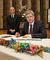 Prime Minister Stephen Harper signing a book of condolence for the victims of the 2011 Tōhoku earthquake and tsunami on March 23, 2011.