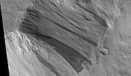 Large group of dark slope streaks along a mesa wall, as seen by HIRISE