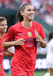 Footballer Alex Morgan, pictured jogging in a red U.S. uniform with the number 13.